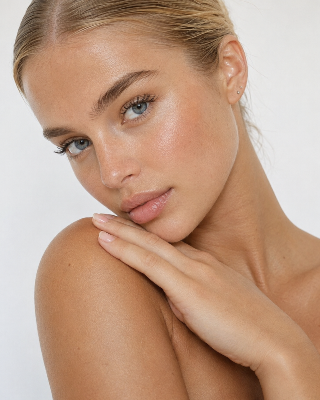 Close-up portrait of a woman with lifted, refreshed midface volume after cheek filler at Juvly Aesthetics